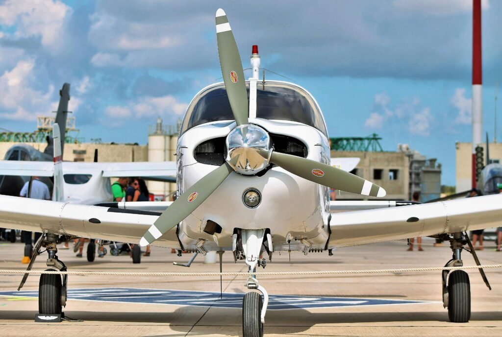 A sleek private aircraft displayed at Luqa airfield in Malta, under a bright sky.